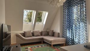 a living room with a couch and two windows at Apartment with parking in Berlin 11 in Berlin