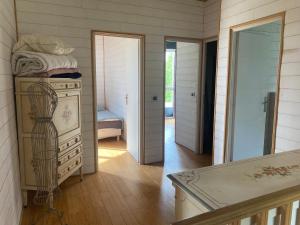 a room with a dresser and a bedroom with a mirror at Domaine des Ecuries vailley in Bouleurs