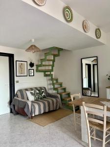 a bedroom with a staircase with a bed and a table at Villa Patty in Marzamemi
