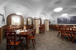 a dining room with wooden tables and chairs at Hotel Zámek Svijany in Svijany