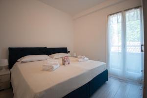 a bedroom with a bed with towels on it at Palazzetto La Quadra di San Faustino - F&L Apartment in Brescia