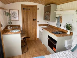 a tiny kitchen with a sink and a counter at Cosy Shepherd's Hut near Shrewsbury in Clive +32 photos