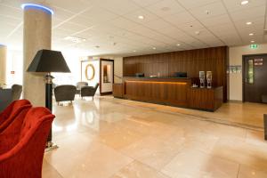 a lobby with a waiting area with chairs and a desk at Hotel Schopenhauer Hof in Frankfurt