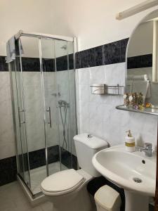 a bathroom with a shower and a toilet and a sink at SeaSide BayView in Faliraki
