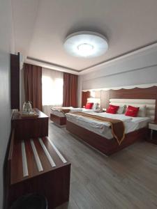 a hotel room with two beds and a television at Adalı Hotel & Suites in Bursa