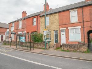 a row of brick houses on a street at Beautiful 5 Guest Property with free parking in Nottingham