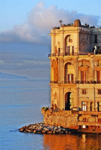 um edifício sentado na água junto ao oceano em Napoli centro storico Un Passo da San Gennaro em Nápoles