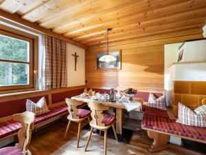 a dining room with a table and chairs at Bauernhof Niederfilzboden in Fieberbrunn