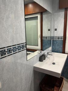 a bathroom with a sink and a mirror at Casa Cancela in Palas de Rei