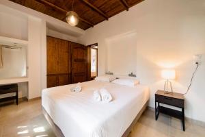 A bed or beds in a room at Ariadni Villas Faliraki