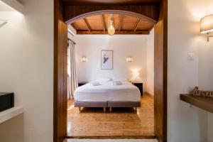 A bed or beds in a room at Ariadni Villas Faliraki