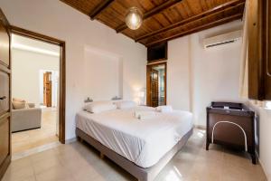 A bed or beds in a room at Ariadni Villas Faliraki