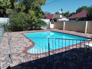 a swimming pool with a fence around it at 10 on Fairview B&B in Paarl