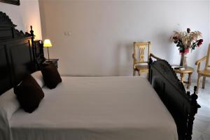 Säng eller sängar i ett rum på Hostal Ciudad Trigueros
