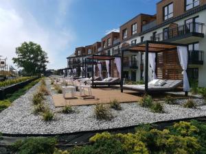 a row of chairs and tables in front of a building at Bel Mare Prestige by Four Seasons in Międzyzdroje