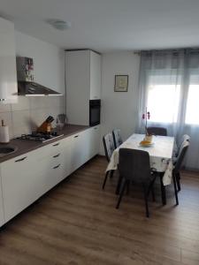 a kitchen with a table and chairs in a room at Apartman Nika in Novi Vinodolski