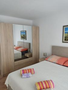 a bedroom with two beds and a large mirror at Apartman Nika in Novi Vinodolski