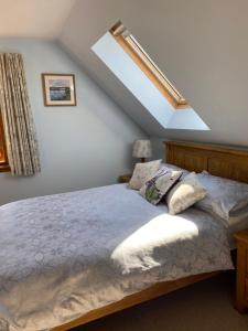a bedroom with a large bed with a roof at Garbhein Bed & Breakfast in Kilmelfort