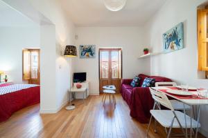 een woonkamer met een rode bank en een tafel bij My City Home - Luminoso apartamento en Puerta del Ángel in Madrid