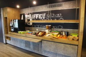 a kitchen with a counter with food on it at ibis budget Nantes Sainte Luce in Sainte-Luce-sur-Loire
