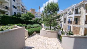 a walkway through a courtyard in a apartment building at Lustica Lux in Tivat