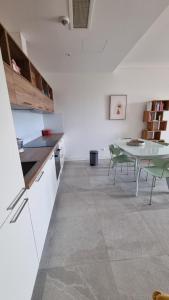 a kitchen and dining room with a table and chairs at Lustica Lux in Tivat