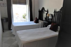 Postel nebo postele na pokoji v ubytování Hostal Ciudad Trigueros