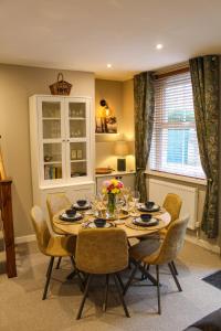 a dining room with a table and chairs and a window at No4 Chapel Row in Bakewell