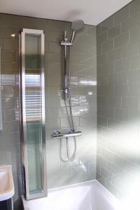 a shower in a bathroom with a tub and a sink at No4 Chapel Row in Bakewell