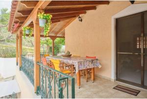 a patio with a table and chairs on a balcony at Villa - Farmhouse in Oropos