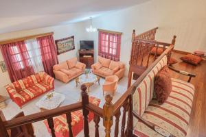 a living room filled with furniture and a staircase at Villa - Farmhouse in Oropos