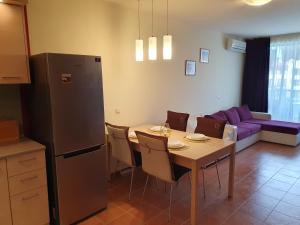 a kitchen and living room with a table and a couch at Sea Star Sozopol in Sozopol