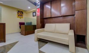 a waiting room with a white couch in a lobby at Itsy By Treebo - Prince Regency in Pune