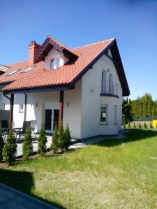 a white house with a red roof at Holiday Home Mierki 2 in Olsztynek