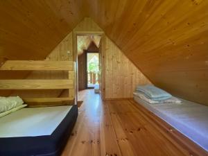 斯蒂格纳Domki Pod Sosnami的大型木制客房,配有两张床