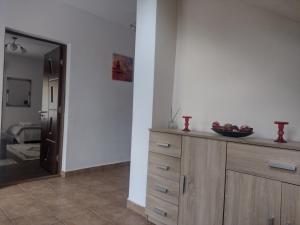 a kitchen with a dresser with a bowl of fruit on it at Casa Radu Novaci in Novaci-Străini +52 photos