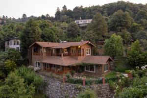 an aerial view of a house at SaffronStays Plaksha - 2BR pet-friendly homestay with Himalayan views, verandah dining & bonfire near Chauli ki Jali in Mukteshwar