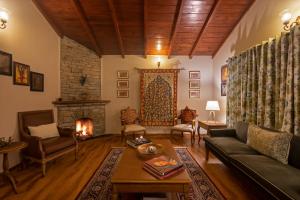 a living room with a couch and a fireplace at SaffronStays Plaksha - 2BR pet-friendly homestay with Himalayan views, verandah dining & bonfire near Chauli ki Jali in Mukteshwar