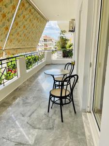 uma mesa e cadeiras numa varanda com vista em Camelia Apartment em Nafplio