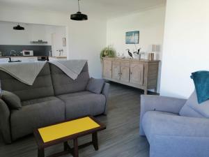 a living room with a couch and a table at Le Barbatrin in Barbâtre