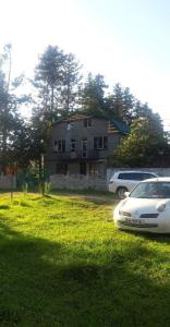 a white car parked in front of a house at Ureki გურიის ქუჩა 47ბ in Ureki