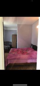 a bedroom with a bed with a purple bedspread at Ureki გურიის ქუჩა 47ბ in Ureki