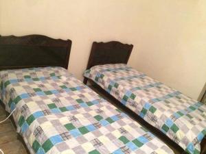 two beds sitting next to each other in a room at Ureki გურიის ქუჩა 47ბ in Ureki +5 photos