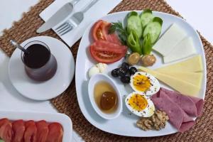 a plate of food with eggs and vegetables on a table at Hotel Grand İstanbul in Istanbul