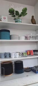 a shelf filled with plates and bowls and dishes at Holiday Hostel in Reykjavík