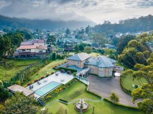 an aerial view of a house with a swimming pool at The Westbury Palace in Nuwara Eliya