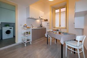 a kitchen with a table and chairs in a room at Sichelgaita Apartment in Salerno