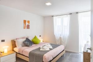 a bedroom with a bed with towels on it at KHL APARTMENTS in Milan