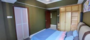 a small bedroom with a bed and a closet at Adella Homestay Pantai Puteri - 5 min Klebang in Melaka