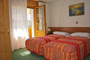 Voodi või voodid majutusasutuse Albergo Ristorante Iris toas